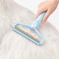 Blue pet hair remover tool gliding smoothly across a thick white coat of pet hair.