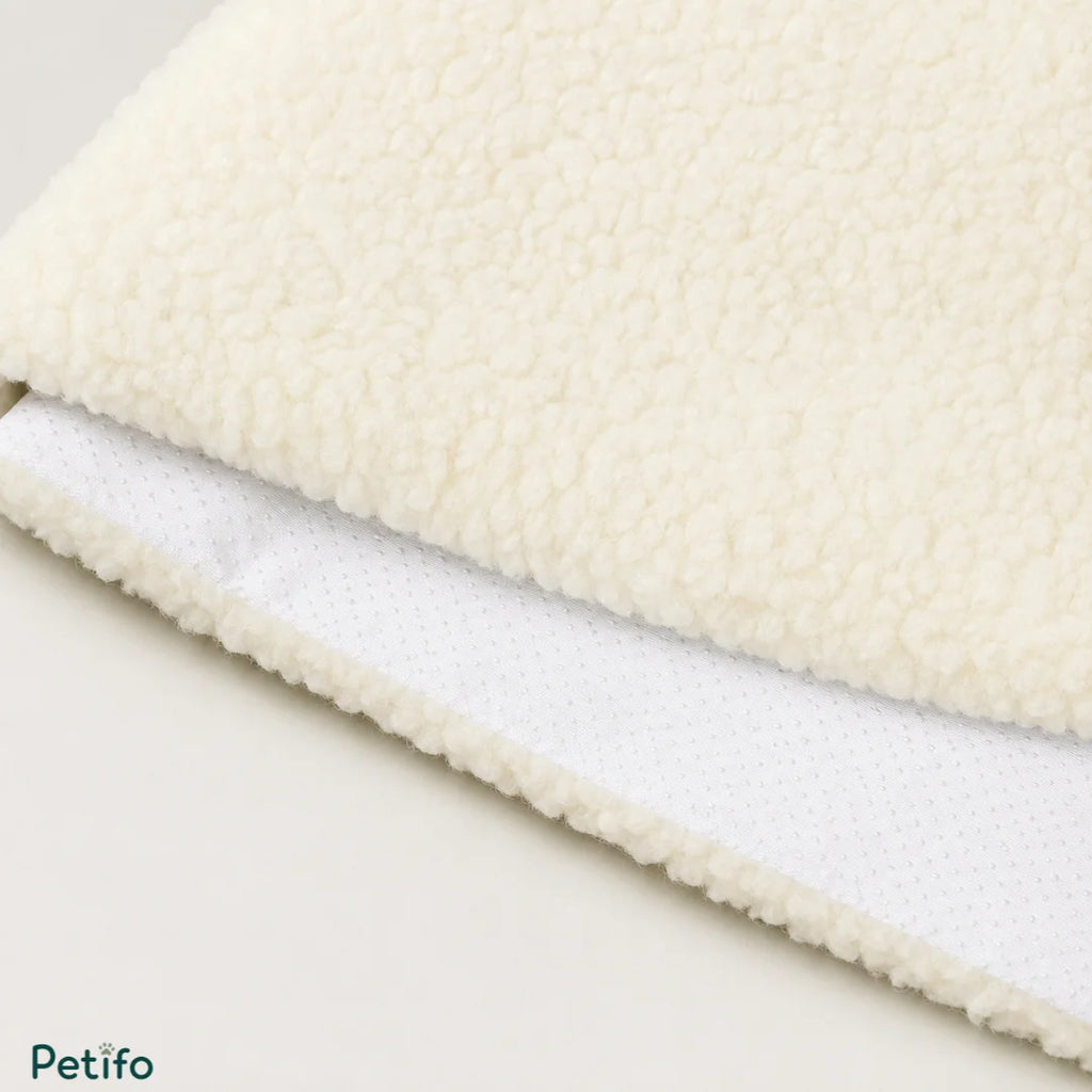 Macro texture shot of the soft, fluffy white fleece top surface and the dotted anti-slip bottom fabric of the mat.