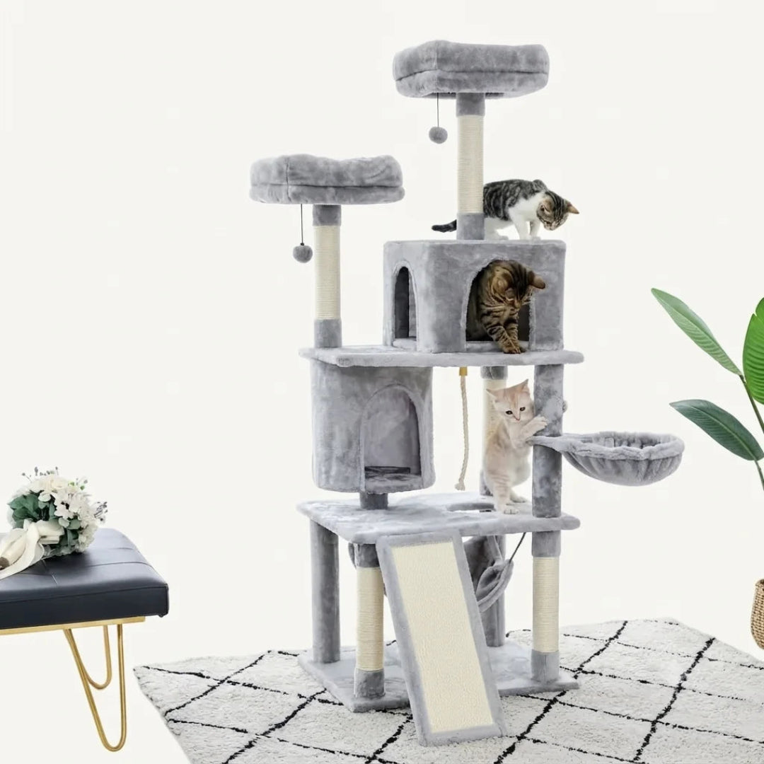 A lifestyle image of a grey multi-level cat tree in a living room, featuring multiple platforms and a central hideaway condo with an internal light.