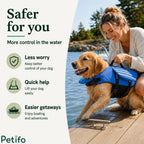 Woman standing on a wooden dock holding the rescue handle of a golden retriever wearing a blue dog life vest.