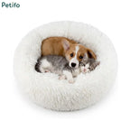 Round white fluffy calming pet bed with an adorable corgi puppy and a grey kitten snuggling together.