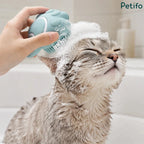 A happy cat closing its eyes blissfully while being washed with the mint green Petifo shampoo brush.