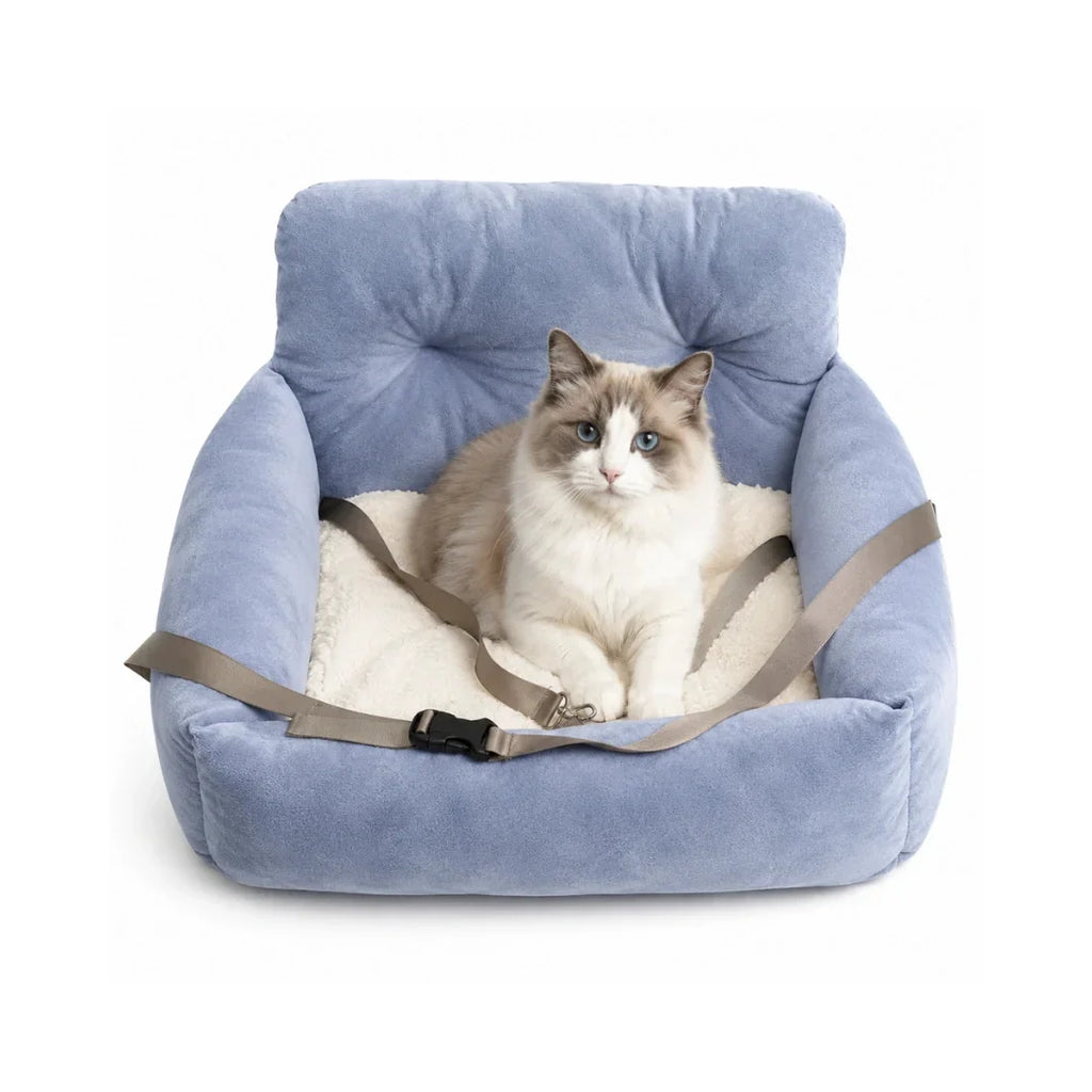 Beautiful ragdoll cat relaxing inside a soft blue plush pet car seat equipped with an adjustable safety strap.