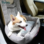 A happy corgi relaxing in a soft, grey Petifo pet car seat securely installed in the front passenger seat of a vehicle.