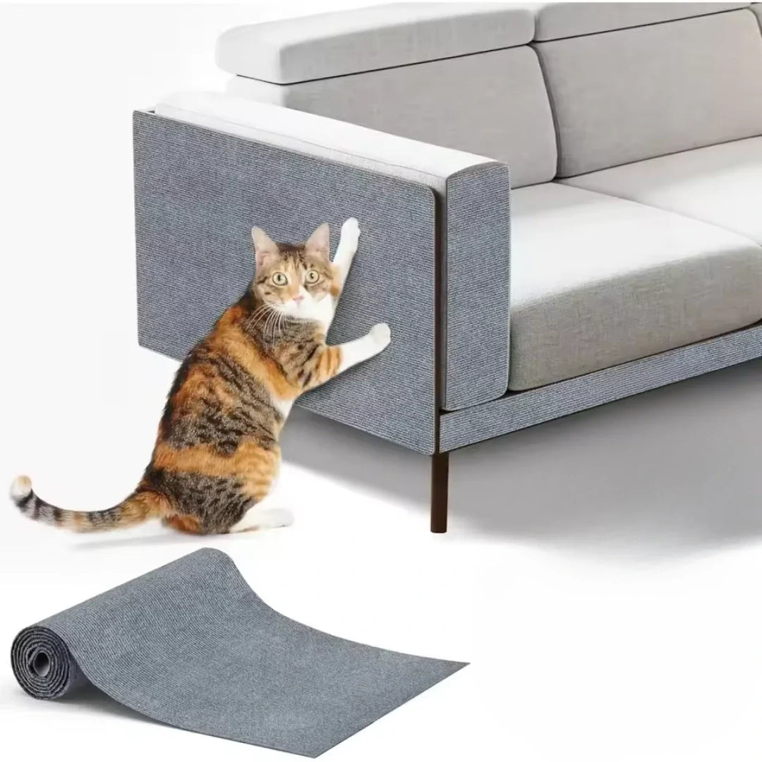 Studio product shot showing a calico cat scratching a grey Petifo cat scratch mat applied to the armrest of a modern sofa, with an unrolled mat in the foreground.