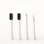 Four white replacement attachment heads for a dog electric toothbrush including two brush heads, a water flosser nozzle, and a scraper.