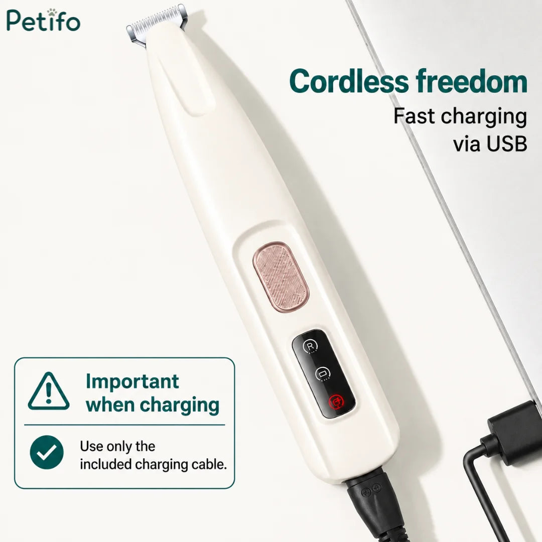 A cordless white pet trimmer connected to a USB charging cable with an important notice about using the included charger.